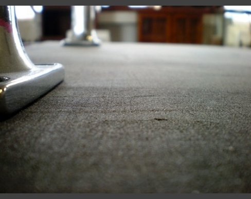 A solid mahogany table top, cut and polished, with Carrol Boyes legs. Mahogany table detail