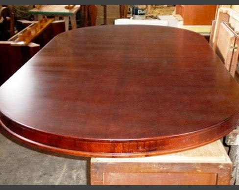 A table top that has been stripped and repolished. Repolished table